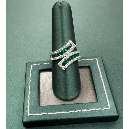 Twisting row emerald and diamond ring