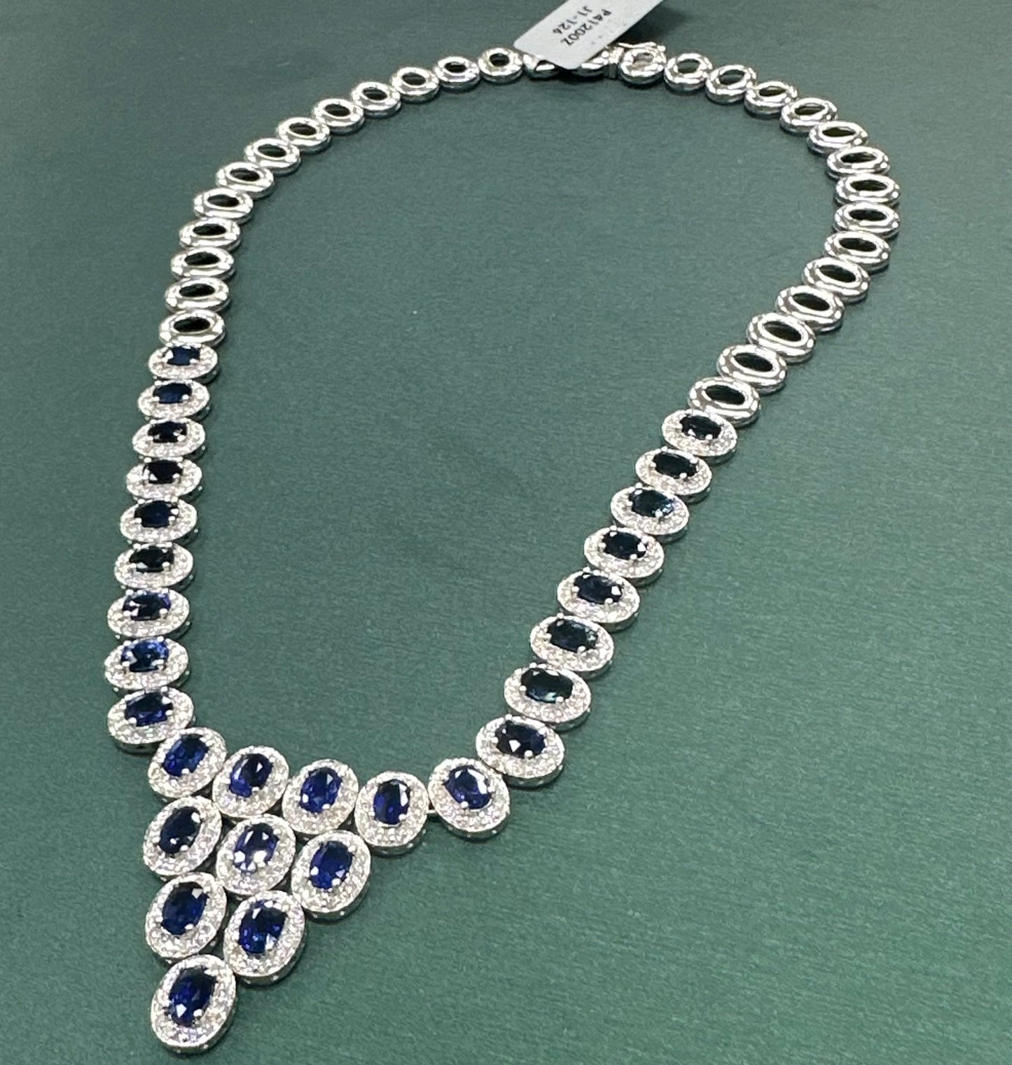 Queen of England sapphire and diamond halo grapevine style