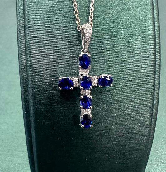 Oval blue sapphire and diamond cross pendant